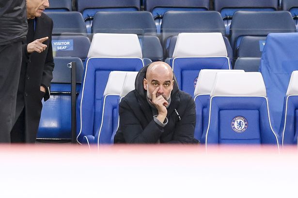 Manchester City Head Coach Pep Guardiola looks on during a game.
